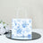 Floral printed gift bag on a reflective surface