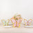 Colorful butterfly decorations on white plates with a floral centerpiece.