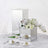 Mirrored cube pedestal centerpiece with white floral arrangement