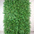 Artificial green fern wall panel for decor and landscaping.