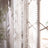 Crystal beaded curtain hanging near a window, creating a sparkling effect.