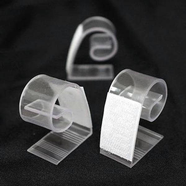 Clear plastic clips for organizing cables and cords.