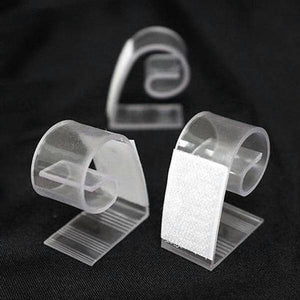 Clear plastic clips for organizing cables and cords.