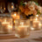 Elegant ribbed glass candle holders glowing softly on a dining table.