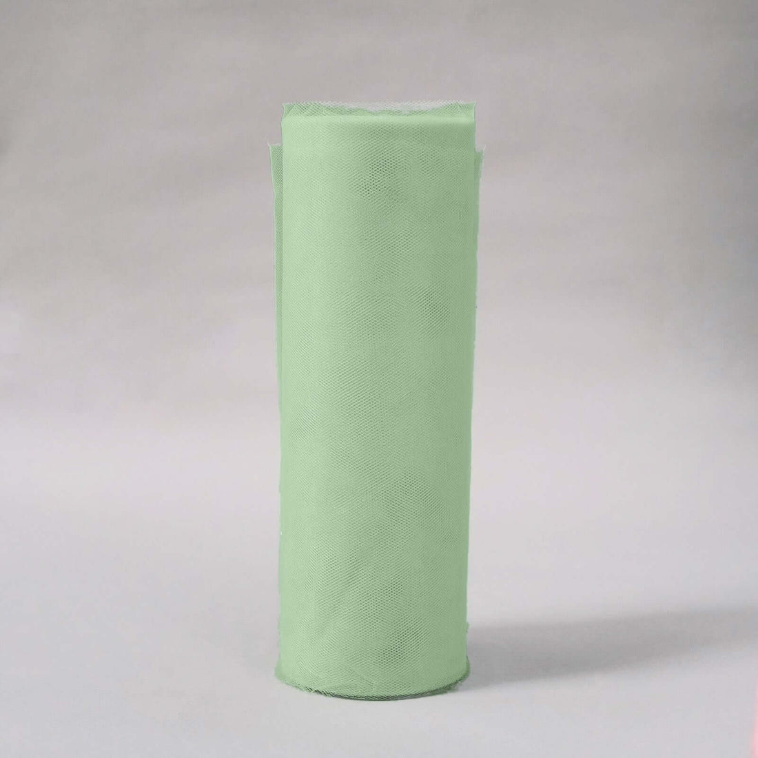 Green fabric roll on a plain backdrop
