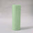 Green fabric roll on a plain backdrop