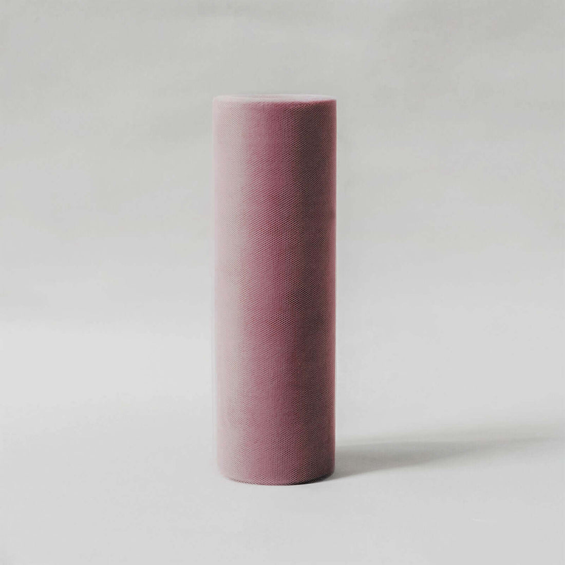 Purple yoga foam roller on a plain background