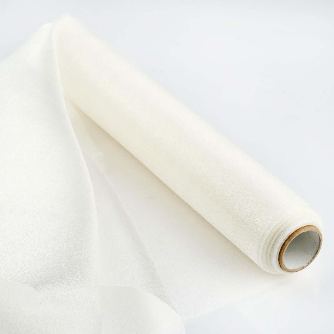Roll of sheer white fabric on a plain white background
