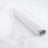 Roll of sheer white fabric on a white background.