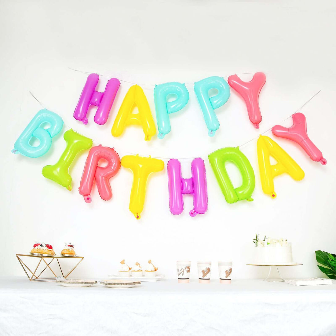 Colorful "Happy Birthday" balloon banner displayed at a festive celebration.
