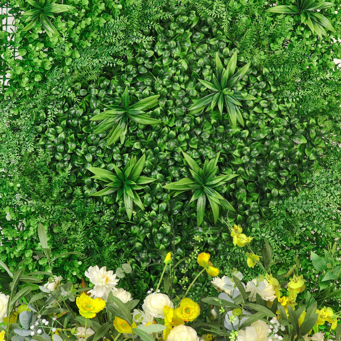 Lush green artificial foliage arrangement with vibrant flowers.