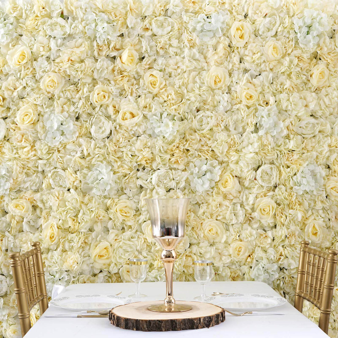 Elegant table setting with gold accents against a floral backdrop.