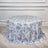Round floral tablecloth in blue and white on a light wooden surface.