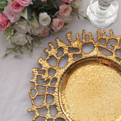 Gold decorative tray with unique texture, surrounded by flowers and a candle holder.