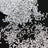 Silver rhinestones scattered on a black surface, showcasing their sparkle and shape.