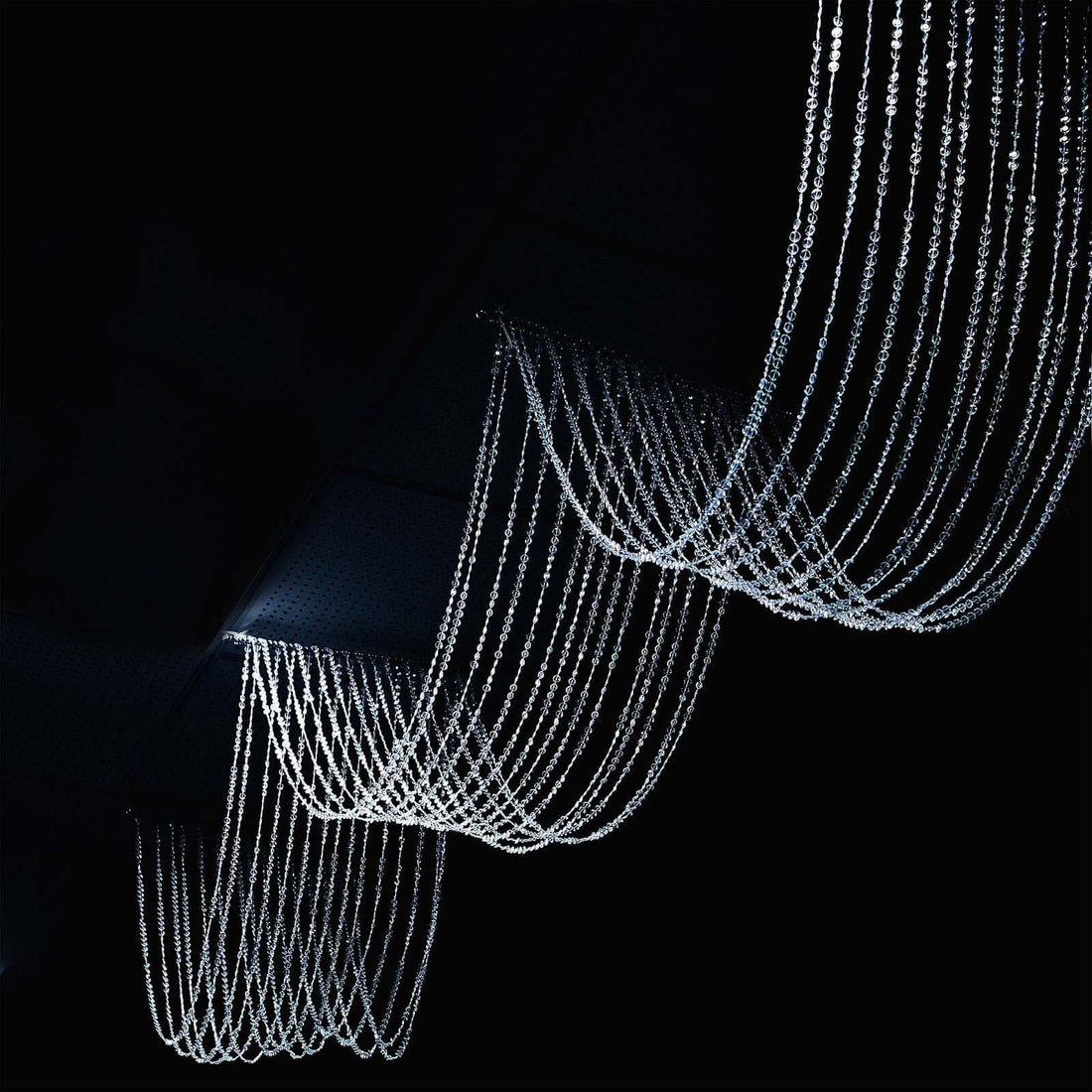 Elegant crystal chandelier with cascading strands of light.