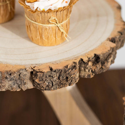 Cupcakes in paper wrappers on a rustic wooden table.