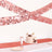 Rose gold party decorations with a cake on a table setting.