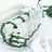 Decorative table setting with greenery, glassware, and white crate.