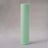Mint green wrapping paper roll on a grey backdrop.