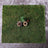 Natural moss mat with pinecones and decorative elements.
