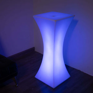 Modern illuminated bar table in blue glow, perfect for stylish events.