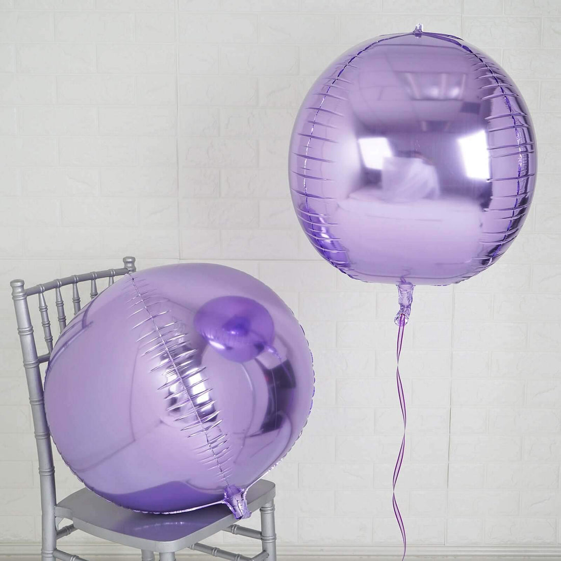Purple metallic balloons on a chair against a light background.