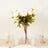 White peony bouquet in a glass vase with candles and elegant table setting