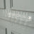 Clear champagne flute rack displaying six elegant glasses.