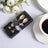 Gold spoon set in elegant packaging with a thank you tag and decorative bow.