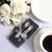 Elegant silver spoons in a gift box, styled with flowers and dinnerware.