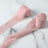 Pink fabric rolls on a marble surface.