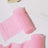 Pink chiffon fabric rolls on a white background.