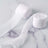 White fabric ribbon rolls on a marble surface.