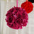 Pink floral ball decoration hanging against a light background.