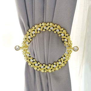 Gold decorative curtain tieback with intricate design and crystal accents.