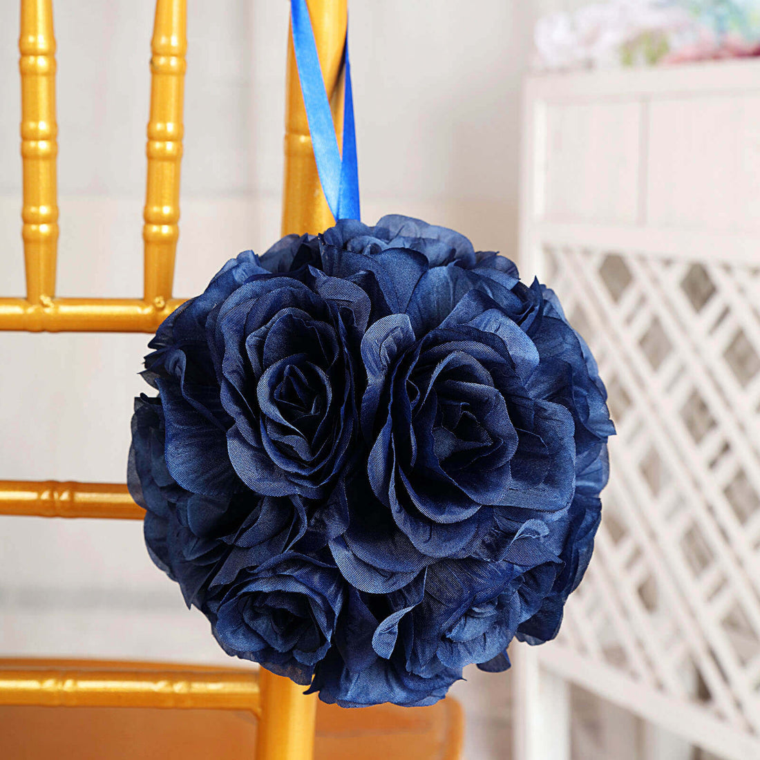 Navy blue fabric flower bouquet hanging from a chair