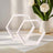 Geometric hexagon decor pieces in white against a soft background.