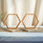 Wooden hexagon decor stands on a table with neutral background.
