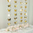 Gold butterfly decorations with pink roses on a table setting for an elegant event.