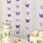 Purple butterfly garland decoration for events with cake and floral arrangements.