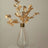 Gold leaf branch arrangement in a clear vase.