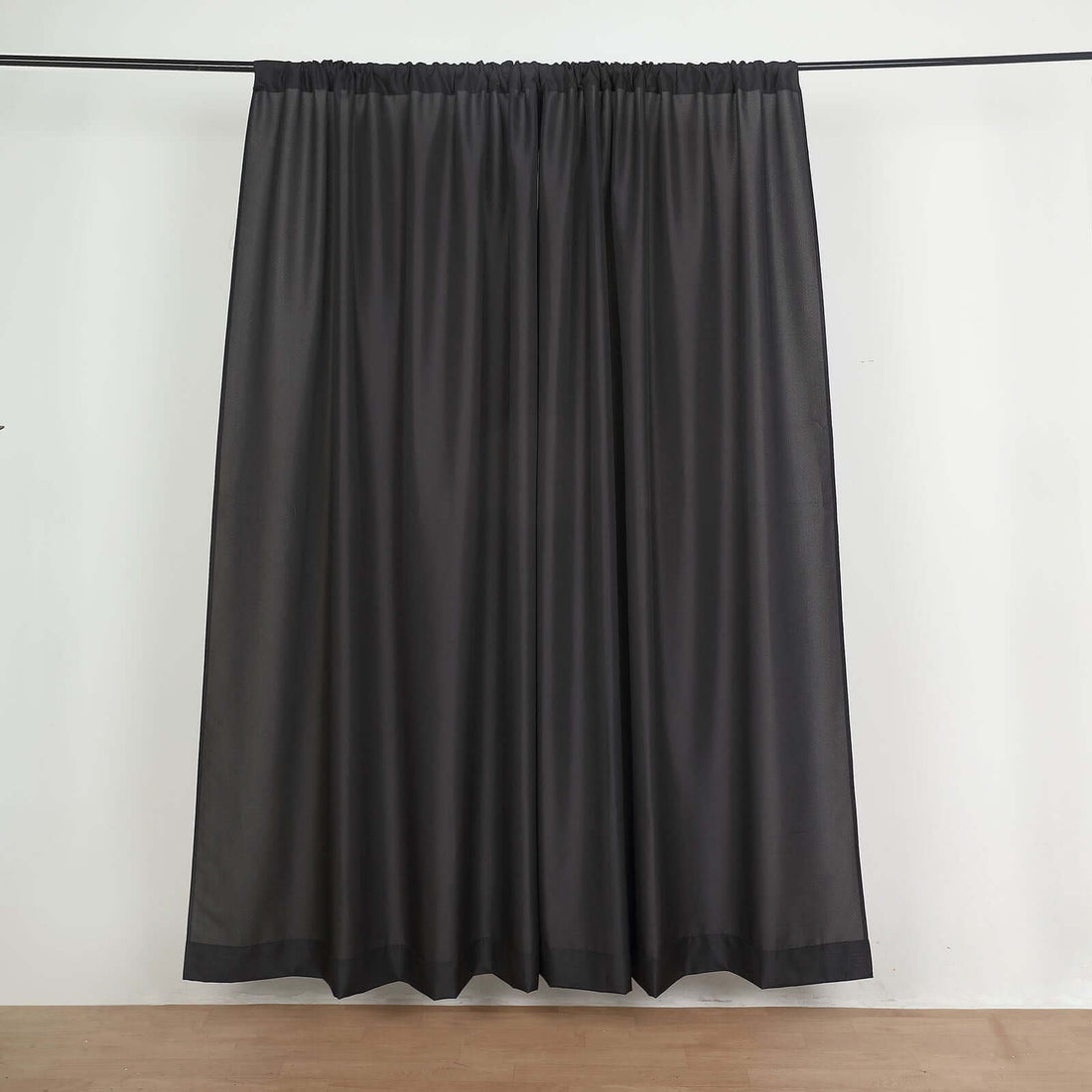 Sheer dark gray curtain panel hanging on a rod