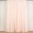 Peach-colored curtain draped on a rod in a studio setting