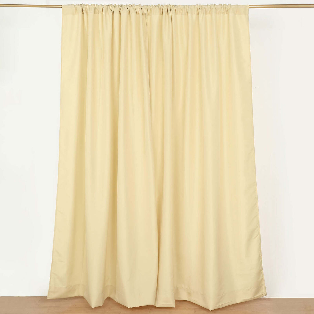 Cream-colored curtain panel hanging on a rod.