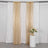 Gold sequin curtain drapes with white backdrop and floral arrangement.
