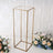 Gold metal display stand with clear top, ideal for showcasing decor.