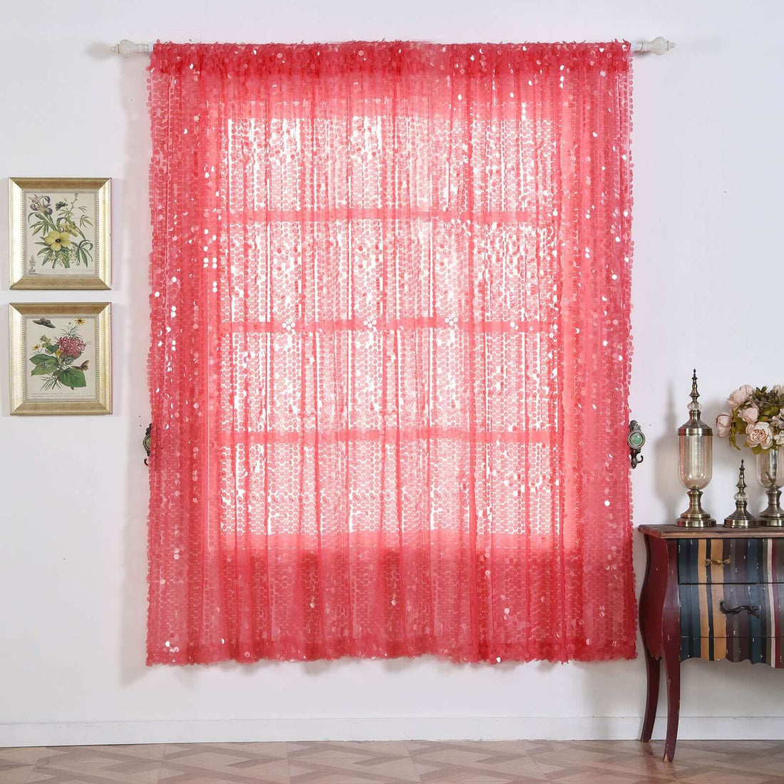 Pink sequin curtain hanging in a styled room with decorative elements.
