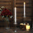 Elegant glass candle holders with white candles and decorative flowers.