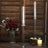 Elegant clear candle holders with candles, surrounded by decorative elements.